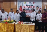 Ketua PMI Kota Jayapura Rustan Saru memberikan potongan nasi tumpeng kepada dewan kehormatan PMI Kota Jayapura 